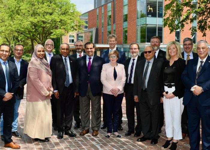 Group of visitors on a sunny green campus